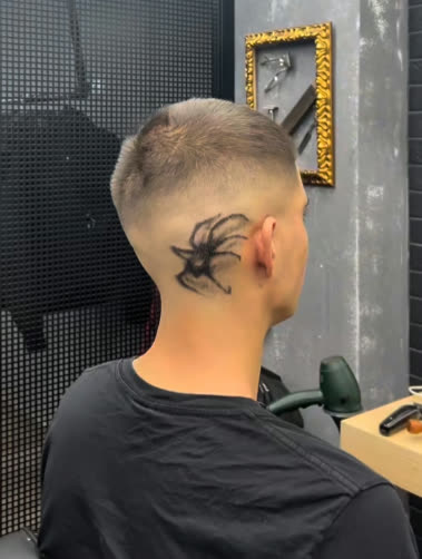 Buzz cut fade with a spider neck tattoo